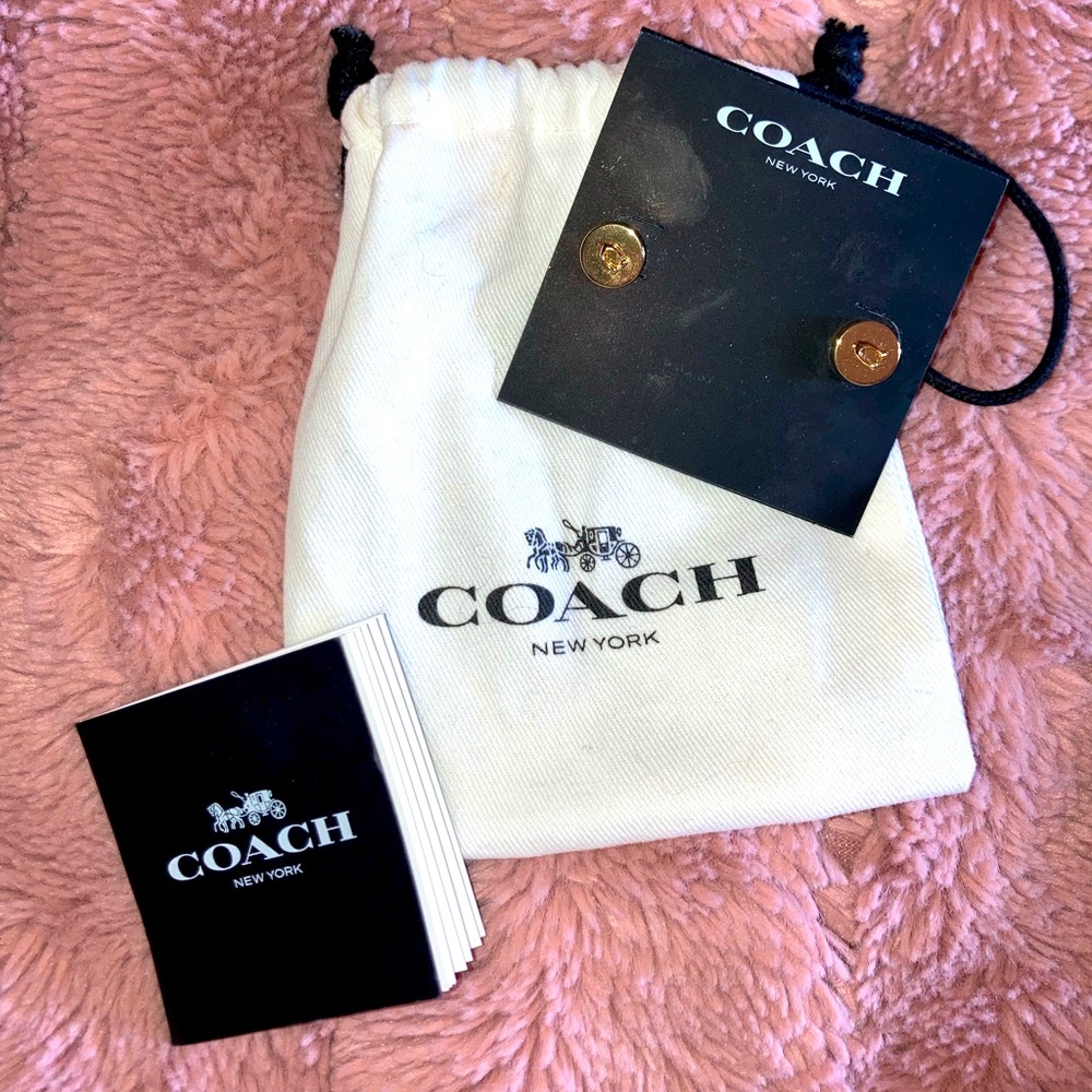 Coach stud earrings never worn with a bag that has a makeup spot on it.
